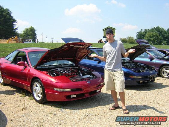Red Ford Probe with hood open, showing engine, parked outdoors