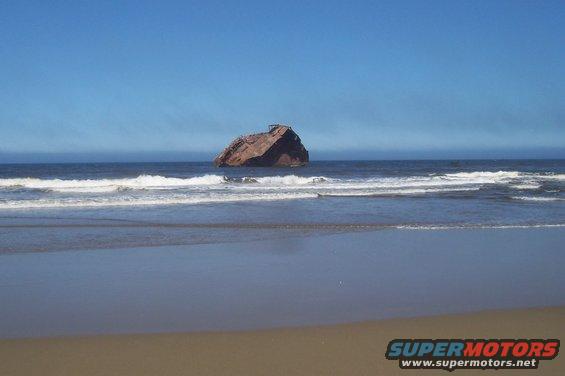 shipwreck on the ocean with waves crashing on the beach