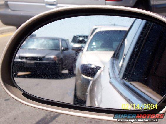 Traffic jam viewed in side mirror. Date stamp reads 02/14/2004