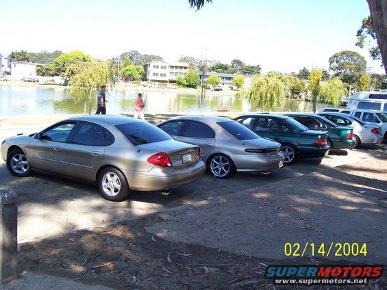 1998 Mercury Sable and other sedans parked in a row near a lake
