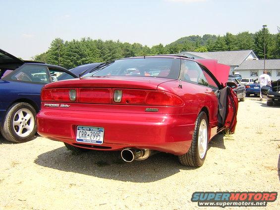 red 1995 Ford Probe GT with hood and door open, parked next to a blue car