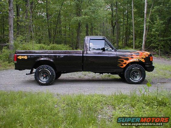 Side view of a 1991 Ford F-150 pickup truck with flame decals