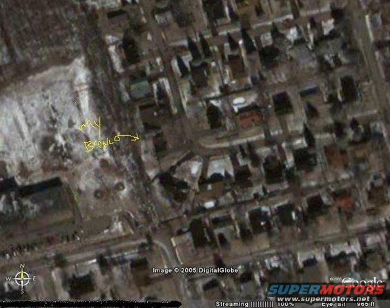 Aerial view of a suburban neighborhood with a yellow arrow and text 'my BRONCO' pointing to a vehicle
