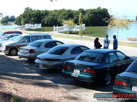 Dark green 1996 Ford Taurus sedan parked in a lot, rear view