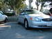 1995 Ford Taurus - Silver sedan parked next to a white truck, showing its front 3/4 view with a California license plate.