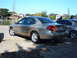 1995 Ford Taurus - Rear view of a gold sedan, possibly a 2000 Ford Taurus, parked outdoors.