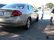 1995 Ford Taurus - This gold sedan's taillights and body style suggest a model year around 2000, not 1995.