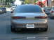 1995 Ford Taurus - Tan Mercury Sable sedan seen from the rear on a city street.