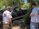 1978 Ford Bronco - A black 1978 Ford Bronco navigates rocky terrain with two onlookers.