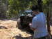 1978 Ford Bronco - A man films an off-road vehicle navigating a rocky trail on a sunny day.