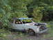 1978 Ford Bronco - This abandoned vehicle sits in a wooded area, showing signs of decay and missing parts.