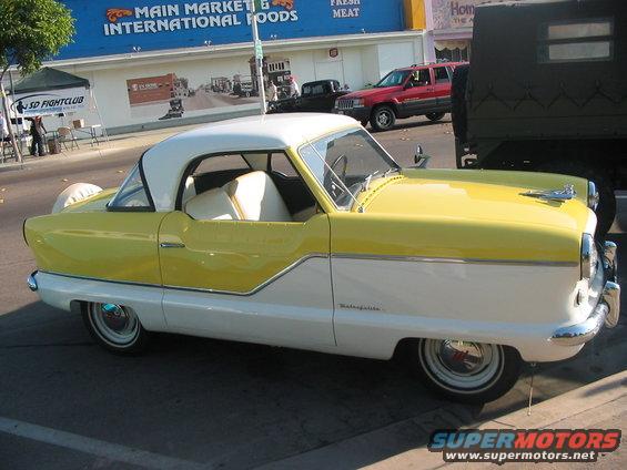 Yellow and white Nash Metropolitan coupe, side view