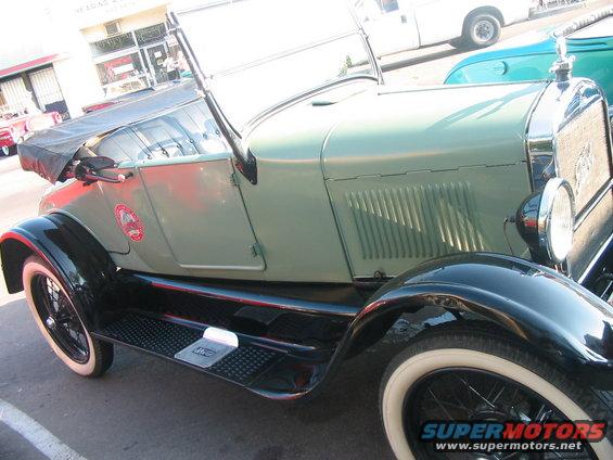 Light green convertible with black fenders and whitewall tires