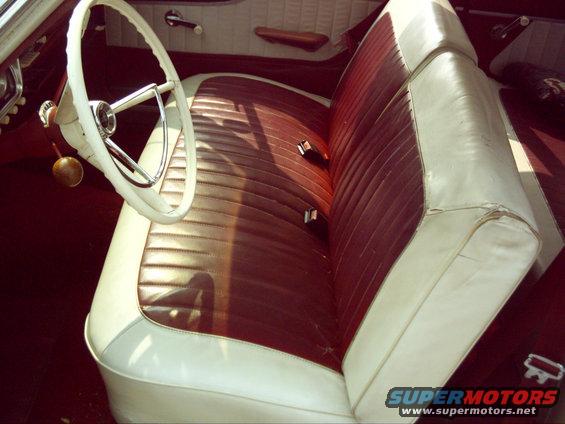 1962 Ford Falcon interior with two-tone brown and white seats, white steering wheel, and wooden shift knob
