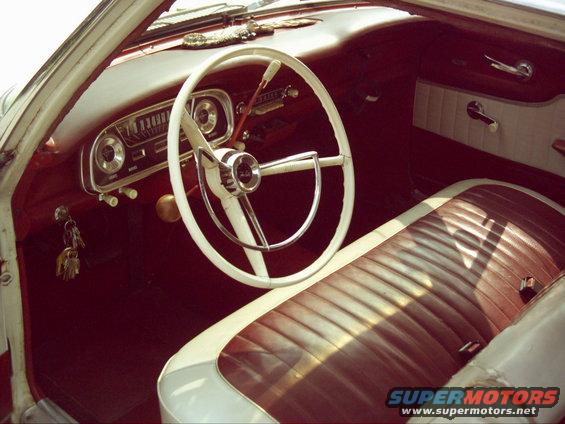 1962 Ford Falcon interior with white steering wheel and red/white seats