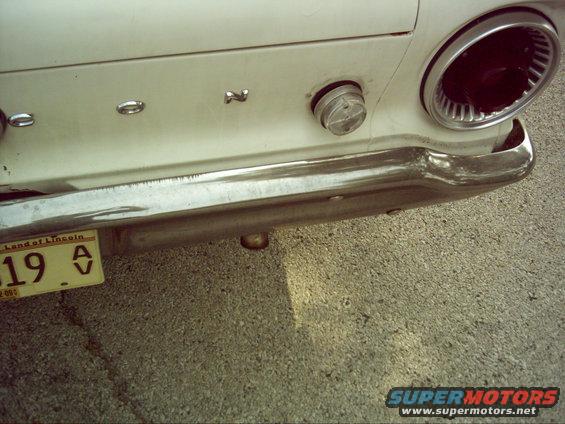 Rear of a 1962 Ford Falcon with a chrome bumper and a taillight visible. License plate from Land of Lincoln is attached