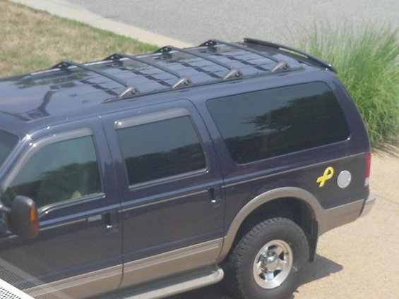 2roof-rack-crossbars-080505.jpg Four modified Explorer crossbars are up off the paint, and get a long load over the rear air deflector.