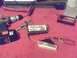 1997 Ford Probe - Car parts, including fog lights and a drill, are laid out on a red surface with tools.