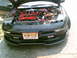 1997 Ford Probe - The engine bay of a black car is visible with custom red accents and a New Jersey license plate.