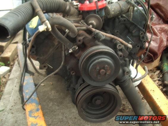 Engine with pulleys and distributor cap