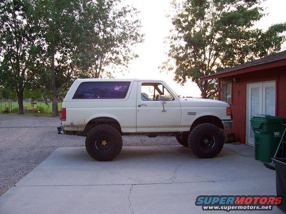 White lifted 1990 Ford Bronco side view