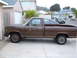 1985 Ford Ranger - A brown pickup truck is parked on a concrete driveway in front of a house.