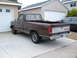 1985 Ford Ranger - This brown 1985 Ford Ranger pickup truck is parked in a driveway next to a garage.