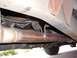 1985 Ford Ranger - Close-up view of the exhaust system and undercarriage components of a vehicle.