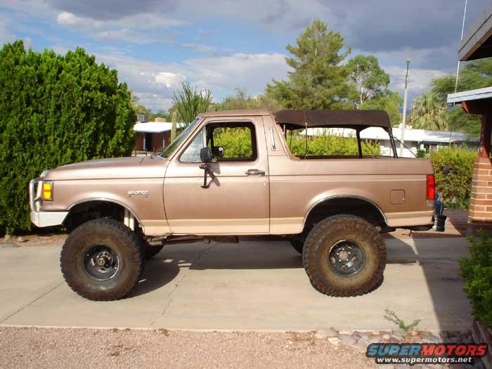 1989 Ford Bronco with a brown soft top, side view