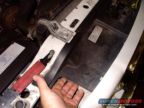 img_0064.jpg To mount it between the A/C condenser and the grill, in the airflow, you need as much access as you can get for the install. This cover needs to come off.