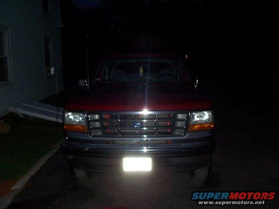 Front view of a red 1992-1996 Ford Bronco with a gray grille and headlights