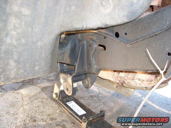 Close-up of vehicle frame and leaf spring assembly, possibly from a truck or SUV