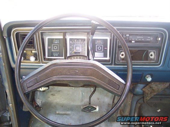 Dashboard of a 1978 Ford Bronco with a steering wheel and gauges