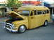 1990 Ford Thunderbird - This custom yellow school bus conversion features a classic front end with the hood open, its engine.