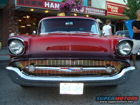 Red 1957 Chevrolet Bel Air front view with chrome grille and bumper