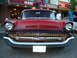 1990 Ford Thunderbird - A classic red Chevrolet is parked on a street in front of a restaurant.