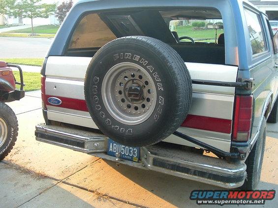 Rear view of 1982 Ford Bronco with spare tire, red stripe, and license plate ABU5033