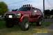 1982 Ford Bronco - This red 1982 Ford Bronco is equipped with a bull bar and multiple lights mounted on the roof rack.