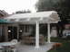 1978 Ford Bronco - Outdoor patio area with furniture and a dog, under a white pergola.
