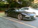 1997 Ford Probe - A black Ford Probe is parked in a lot next to a white car, showing its front 3/4 view.