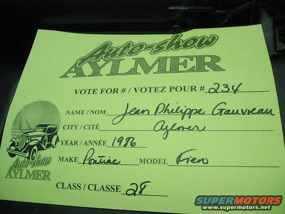 Green auto show ballot with handwritten entries for name, city, year 1986, make Pontiac, model Fiero, and class 28