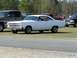 1966 Ford Fairlane - A white 1966 Ford Fairlane is parked on a grassy area with other vehicles nearby.