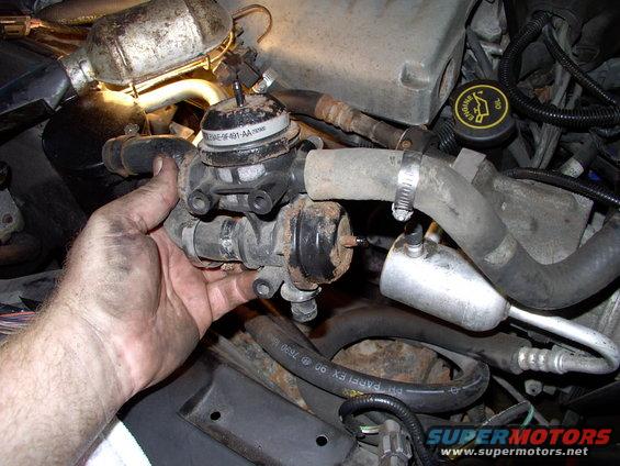 Two 3/8" mounting bracket bolts, three air pump hose clamps and two vacuum hoses disconnected and this air pump diverter valve will actually come out.