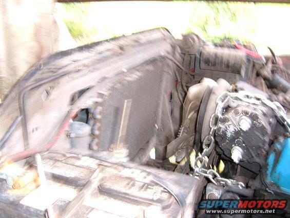 engine bay with chains around some components, blurry