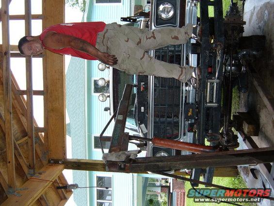 1978 Ford Bronco front grille and bumper with a man standing on it
