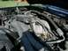 1992 Ford Bronco - Close-up view of an engine bay, showing various hoses and mechanical parts.