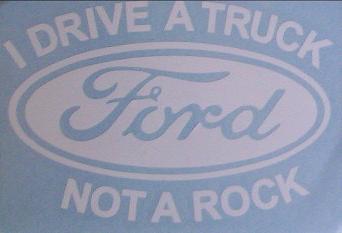 White Ford oval logo with text 'I DRIVE A TRUCK NOT A ROCK' on blue background
