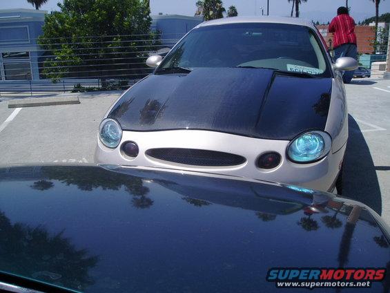 1998 Mercury Sable with carbon fiber hood parked next to another car