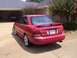 2002 Nissan SE-R - Rear view of a red Nissan Sentra sedan parked outside a residential garage.