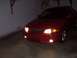 2002 Nissan SE-R - Front view of a red 2002 Nissan SE-R sedan parked indoors with its headlights illuminated.